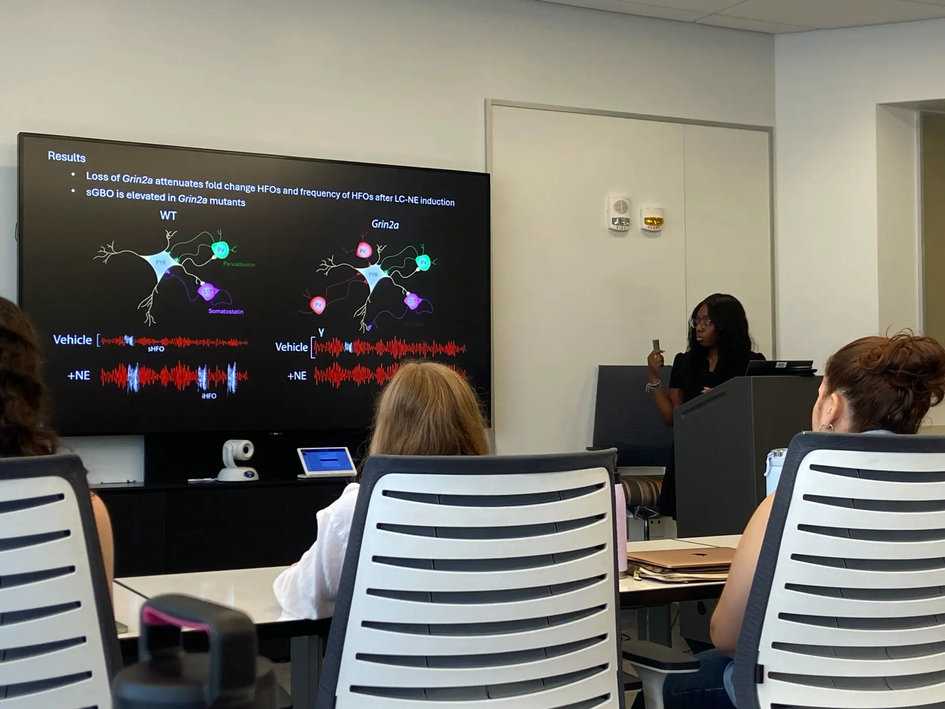 Sky presenting her neuroscience research results to a symposium audience