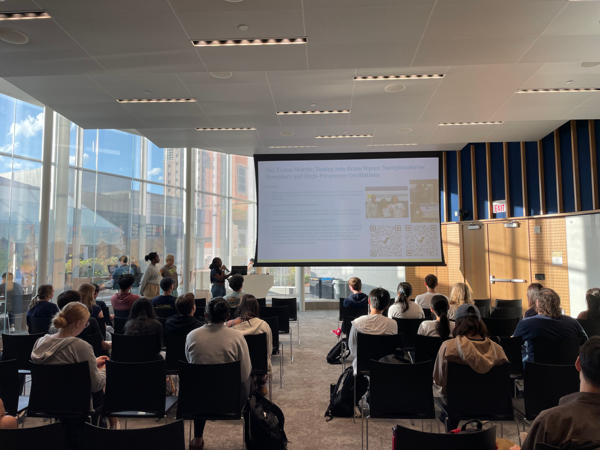 Sky presenting research opportunities to transfer students in a campus event space